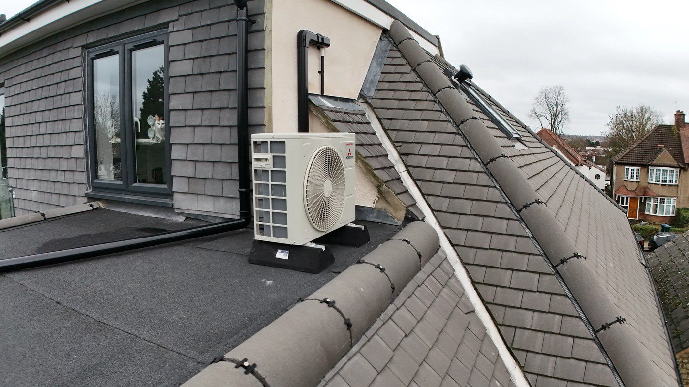 Close-proximity view of tile-to-flat-roof junction showing mortar bedding condition