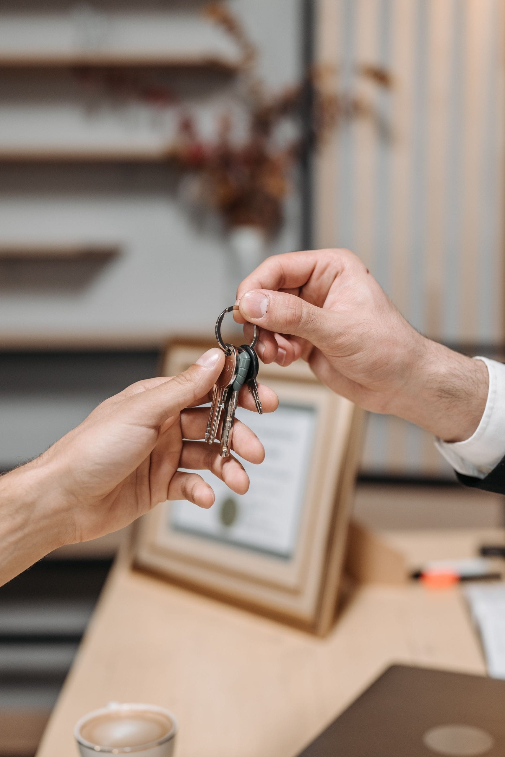 A landlord handing house keys to a new tenant